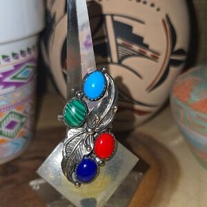 Sterling silver ring featuring a leaf design with multi colored gemstones.